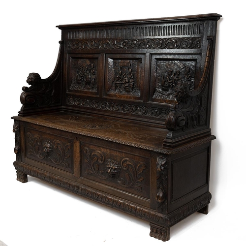 453 - Late 19th Century Flemish oak settle, heavily carved throughout. The back with three inset fielded p... 