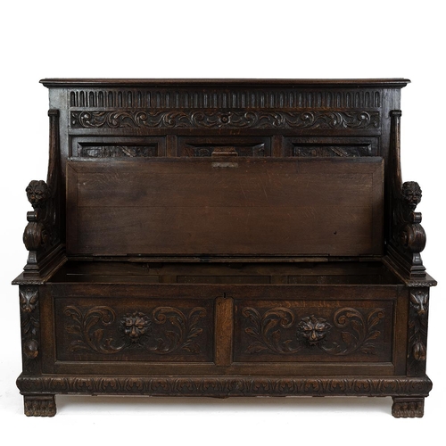 453 - Late 19th Century Flemish oak settle, heavily carved throughout. The back with three inset fielded p... 