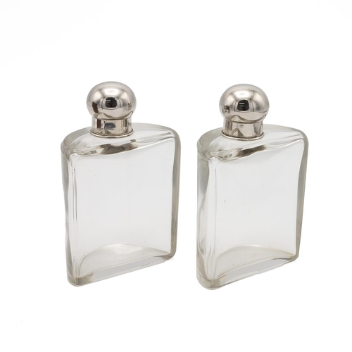 78 - Pair of early 20th century travelling spirit flasks, of semi-circular form with chromed tops, contai... 