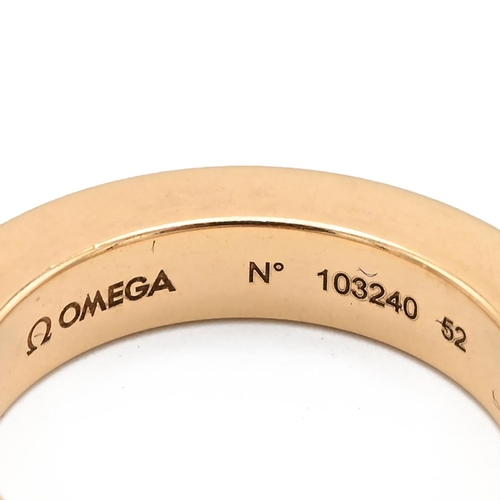 1 - An 18ct gold Omega band, the plain band with serial number 103240, 52, set with a single brilliant c... 