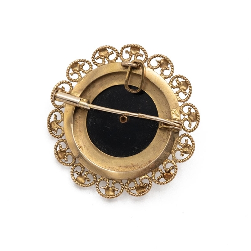 114 - An 18ct gold brooch of circular form, with a central star set with a seed pearl mounted on an onyx b... 