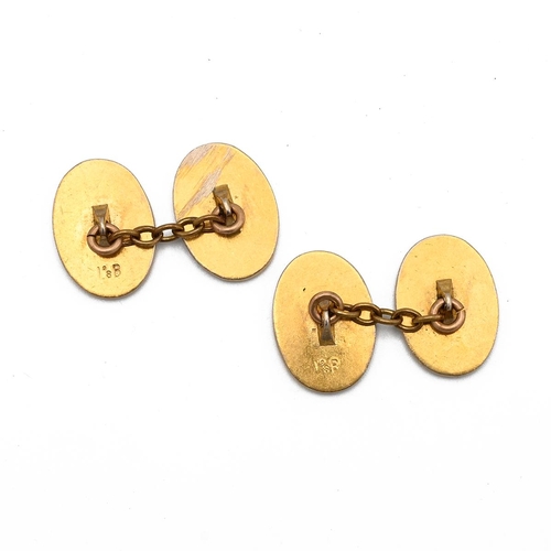 130 - A pair of gilt metal and enamel cufflinks, the oval terminals enamelled with a crest and stripes.