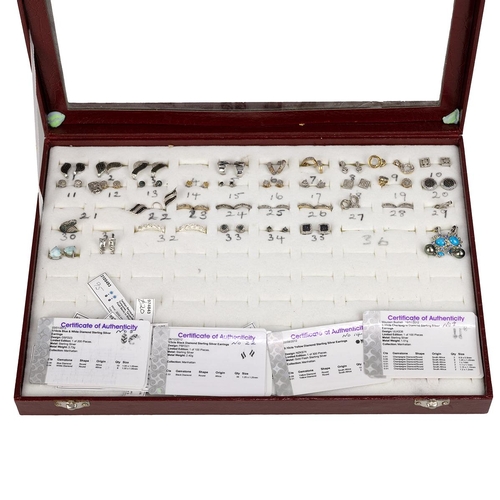 133 - Various gem set and silver earrings, pendants and rings, are contained in fitted display cases, appr... 