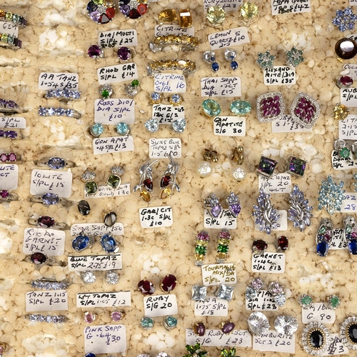 134 - Large collection of silver gem set stud and clip earrings, in an associated wooden case. 