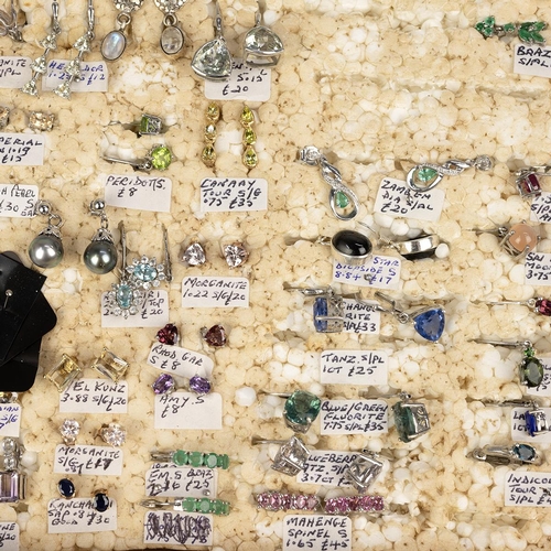 134 - Large collection of silver gem set stud and clip earrings, in an associated wooden case. 