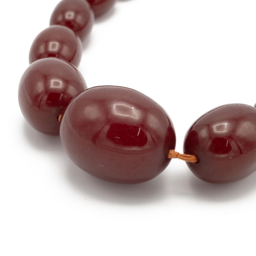 151 - Cherry amber bead necklace, set with graduated beads, 49cm long, 79.49g