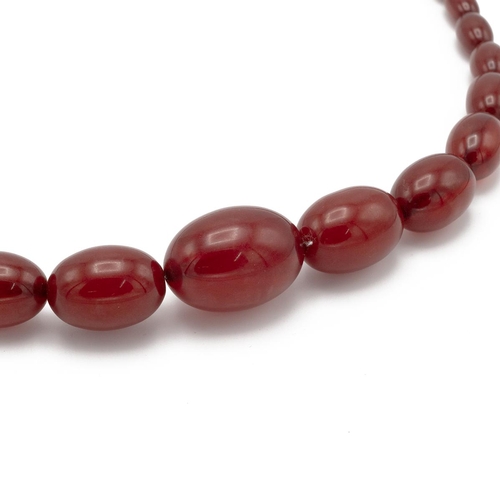 152 - A cherry amber bead necklace, set with graduated beads, total length 78cm, total weight 62g.