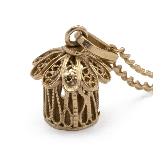 156 - African yellow metal in the form of a native African hut with filigree decoration tested as 14ct wei... 