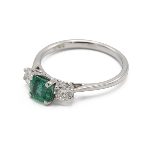 16 - Emerald and diamond three stone ring, the square cut stone flanked either side by a brilliant cut, t... 