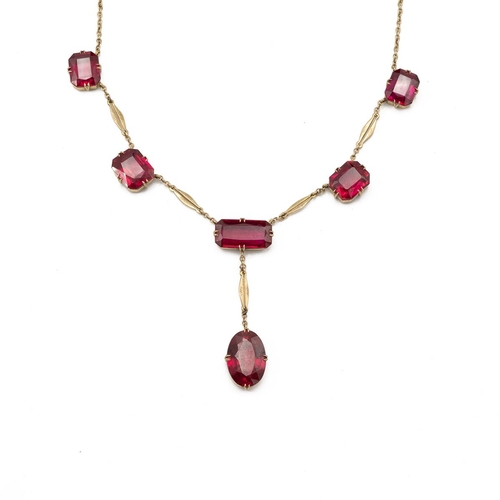 166 - A synthetic ruby necklace, the six stones to a drop frontispiece on a back chain, 12.9g gross.