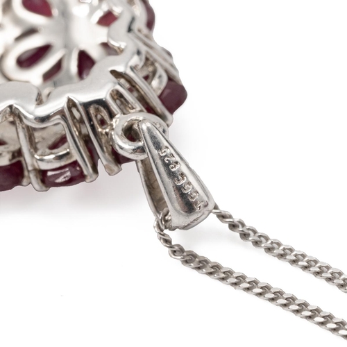 191 - Ruby and diamond cluster pendant on a chain, stamped ’925’.