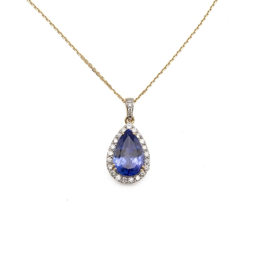 196 - A Tanzanite and diamond pendant on a chain, the pendeloque stone estimated as weighing approximately... 