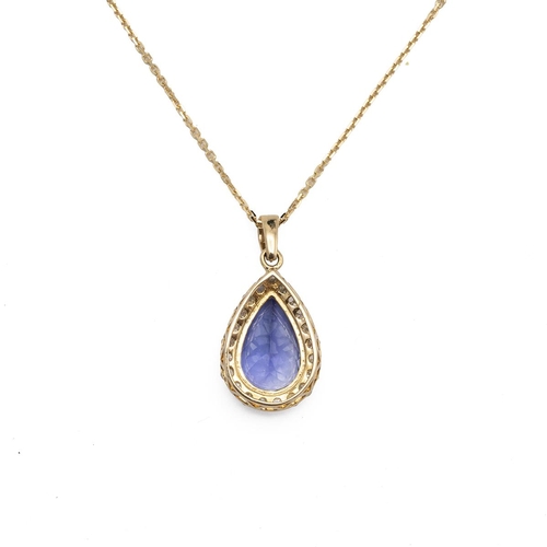 196 - A Tanzanite and diamond pendant on a chain, the pendeloque stone estimated as weighing approximately... 