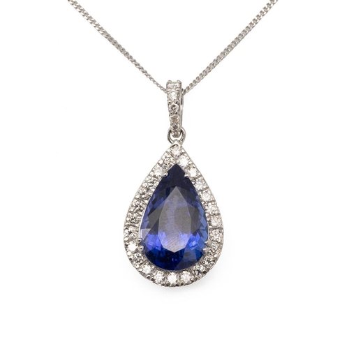 197 - A tanzanite and diamond pendant on a chain, the pendeloque cut stone measuring approximately 15.5 mm... 