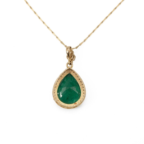 198 - An emerald and diamond pendant on a chain, the pendeloque cut stone measuring approximately 18.5 mm ... 