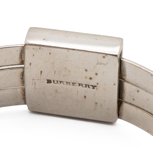 206 - Burberry silver triple bangle, set with a square panel and coloured enamelled cells, 6.6cm internal ... 