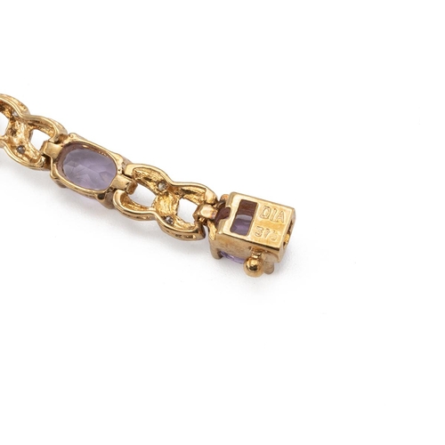 215 - A diamond and amethyst 9ct gold bracelet, the fourteen oval cuts with pairs of small single cuts bet... 