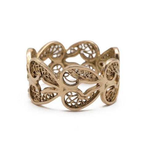 33 - An African yellow metal ring, the band decorated with hearts and filigree decoration tested as 14ct,... 