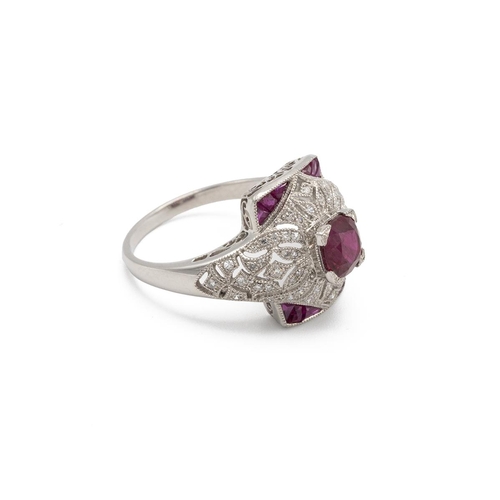 42 - Ruby, calibre cut ruby and diamond ring, of almost bombe design, with calibre cut stones to the corn... 