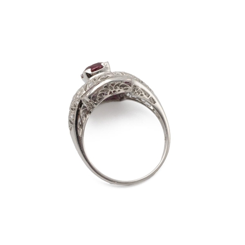 42 - Ruby, calibre cut ruby and diamond ring, of almost bombe design, with calibre cut stones to the corn... 