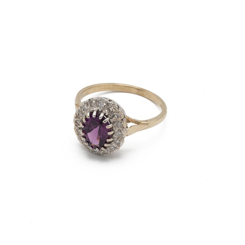 49 - Amethyst and diamond 9ct gold cluster ring, the oval cut enclosed by sixteen small diamonds, finger ... 