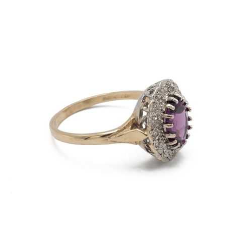 49 - Amethyst and diamond 9ct gold cluster ring, the oval cut enclosed by sixteen small diamonds, finger ... 