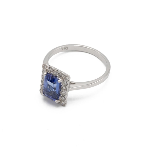 53 - Tanzanite and diamond cluster ring, the step cut stone estimated as weighing approximately 1.4ct, en... 