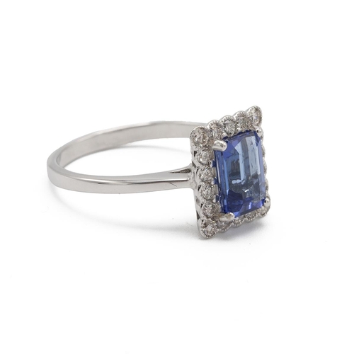 53 - Tanzanite and diamond cluster ring, the step cut stone estimated as weighing approximately 1.4ct, en... 