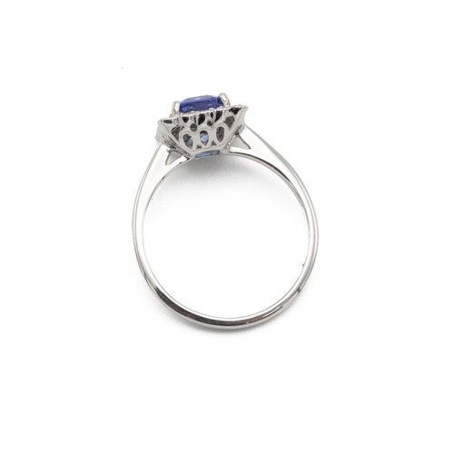 53 - Tanzanite and diamond cluster ring, the step cut stone estimated as weighing approximately 1.4ct, en... 