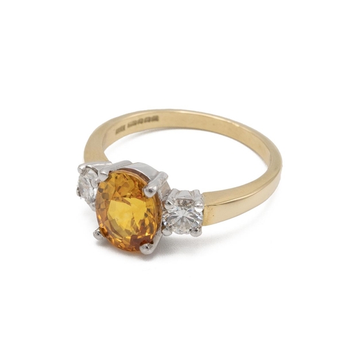 62 - A yellow sapphire and diamond three stone 18ct gold ring, the oval cut sapphire measuring approximat... 