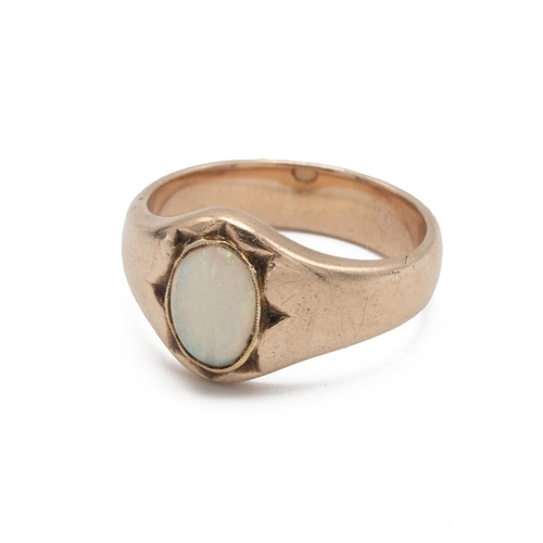 66 - An opal set ring, the oval shallow cabochon in an unmarked rose coloured mount, finger size S, 7.4g ... 