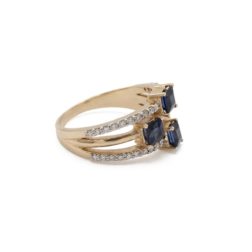 74 - A three stone sapphire and diamond dress ring, the three square cuts set to individual shanks, the c... 