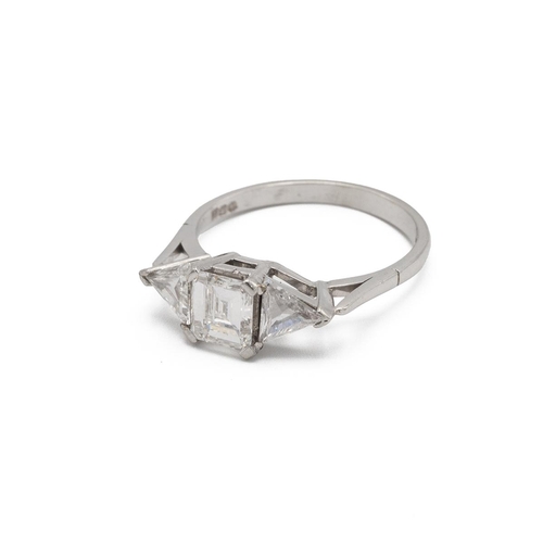 77 - A three stone diamond set platinum ring, the central step cut diamond estimated as weighing approxim... 