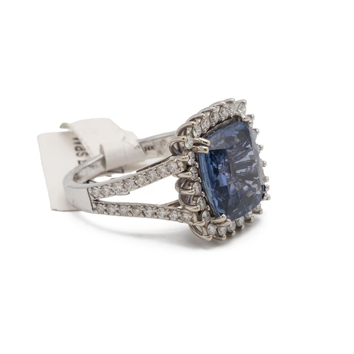 80 - A sapphire and diamond cluster ring, the cushion cut stone measuring approximately 12 mm by 11 mm by... 