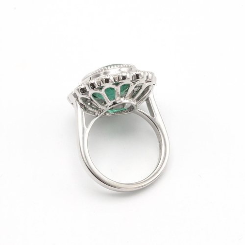 81 - Emerald and diamond cluster ring, the oval cut stone estimated as weighing approximately 7.5ct, encl... 