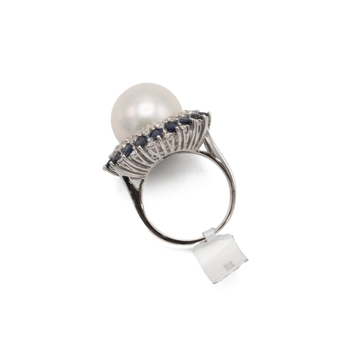 82 - A South Sea cultured pearl, diamond and sapphire dress ring, the 14mm pearl enclosed by alternate se... 