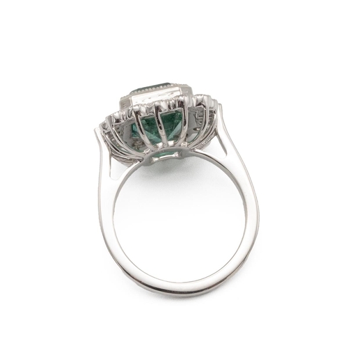 87 - Emerald and diamond cluster ring, the step cut stone estimated as weighing approximately 4.8ct, encl... 