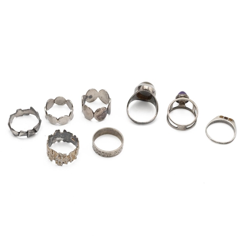 88 - A collection of five Peter Guy Watson silver rings, one set with a cabochon amethyst; with three oth... 