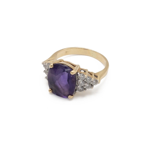 92 - An amethyst and diamond cluster ring, the cushion-shaped fancy cut flanked to either side by six bri... 