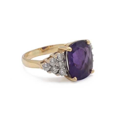 92 - An amethyst and diamond cluster ring, the cushion-shaped fancy cut flanked to either side by six bri... 