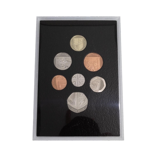 108 - Two (2) Royal Mint base metal commemorative coin sets. Includes 2008 Royal Shield of Arms seven-coin... 