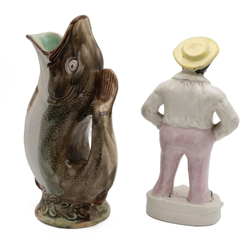 169 - A Jack Tar Staffordshire flatback figurine, 19th century,  and a majolica glazed fish gurgle jug. (2... 