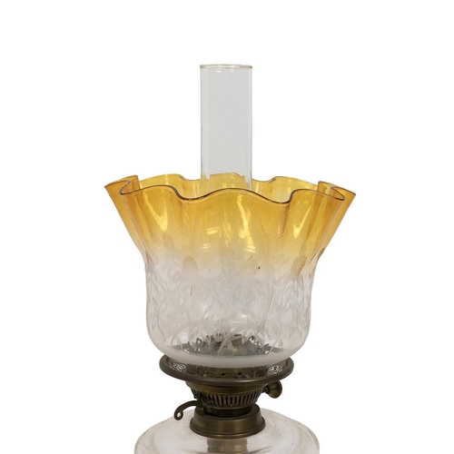 194 - Turn of the century paraffin lamp with black glass socle base supporting a brass stem, a pressed cle... 