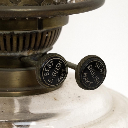 194 - Turn of the century paraffin lamp with black glass socle base supporting a brass stem, a pressed cle... 