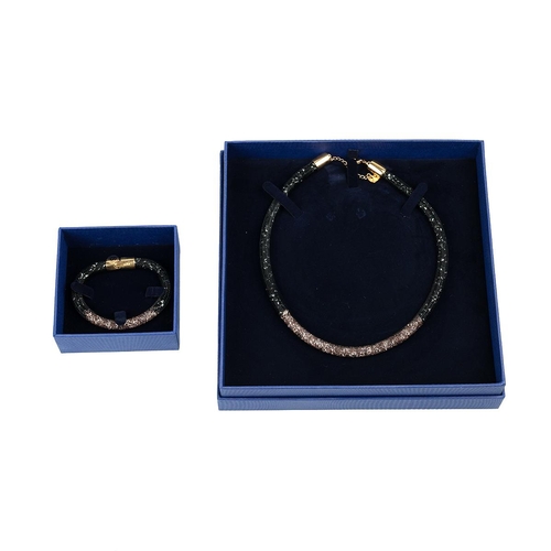 27 - Boxed Swarovski crystal jewellery. Stardust bracelet (size S) and necklace (42cm); Gold plated Pave ... 