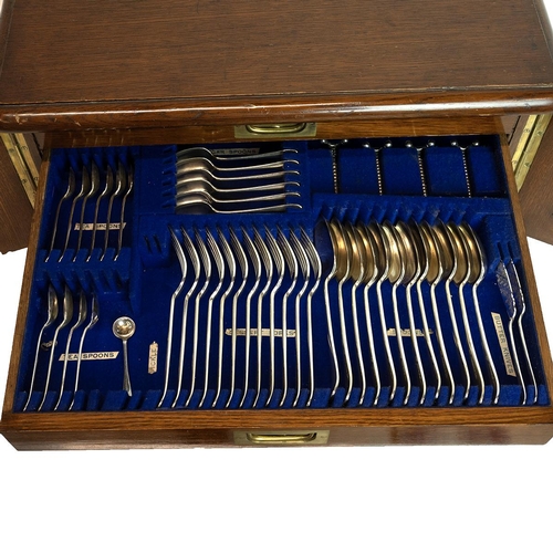 316 - Mid 20th Century oak cased canteen of cutlery. Small cabinet with lockable hinged doors (key present... 