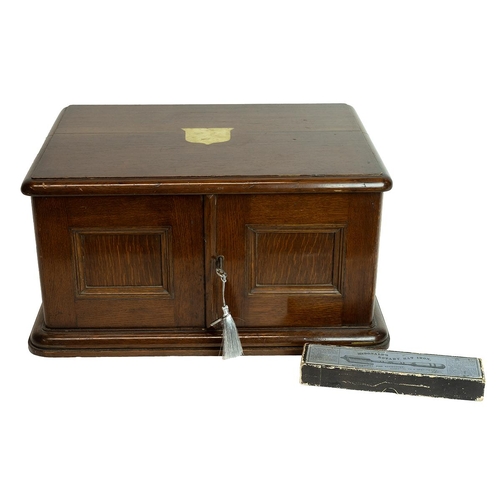 316 - Mid 20th Century oak cased canteen of cutlery. Small cabinet with lockable hinged doors (key present... 