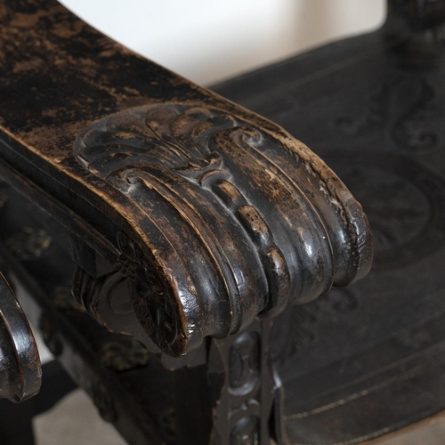 349 - Pair of Italian walnut and tooled leather armchairs, later 19th Century. Carved detailing to the fro... 