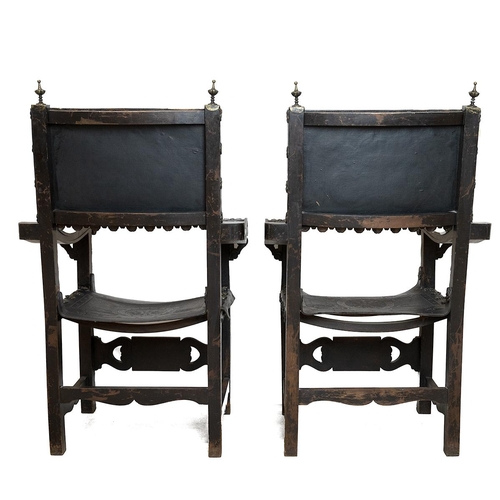 349 - Pair of Italian walnut and tooled leather armchairs, later 19th Century. Carved detailing to the fro... 