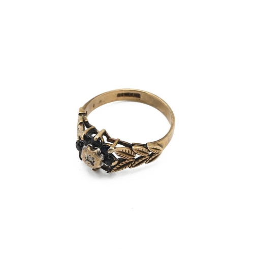 4 - 9ct gold ring with a central white stone supported by a leaf setting, 2.45 grams, with box.